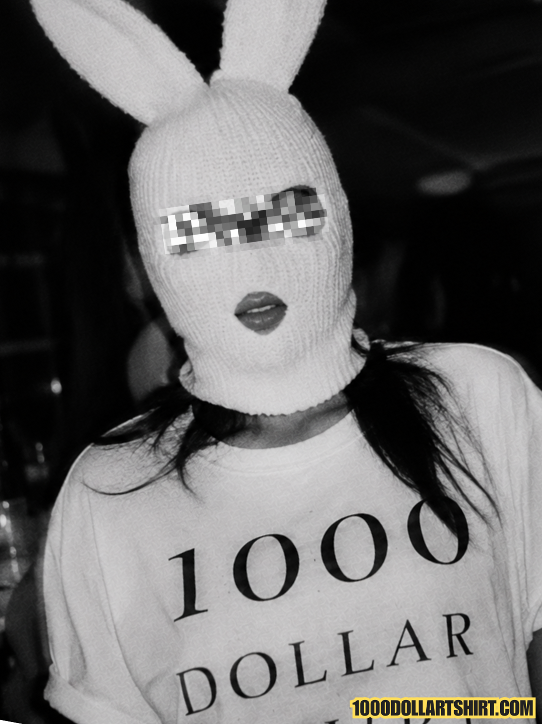 Black and white flash portrait of a woman wearing a white bunny balaclava and a 1000 Dollar T Shirt at a crowded nightclub.
